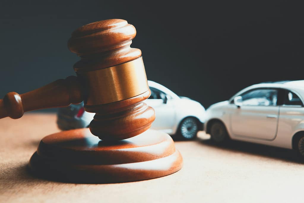 Legal gavel beside toy cars representing California car accident and fault determination