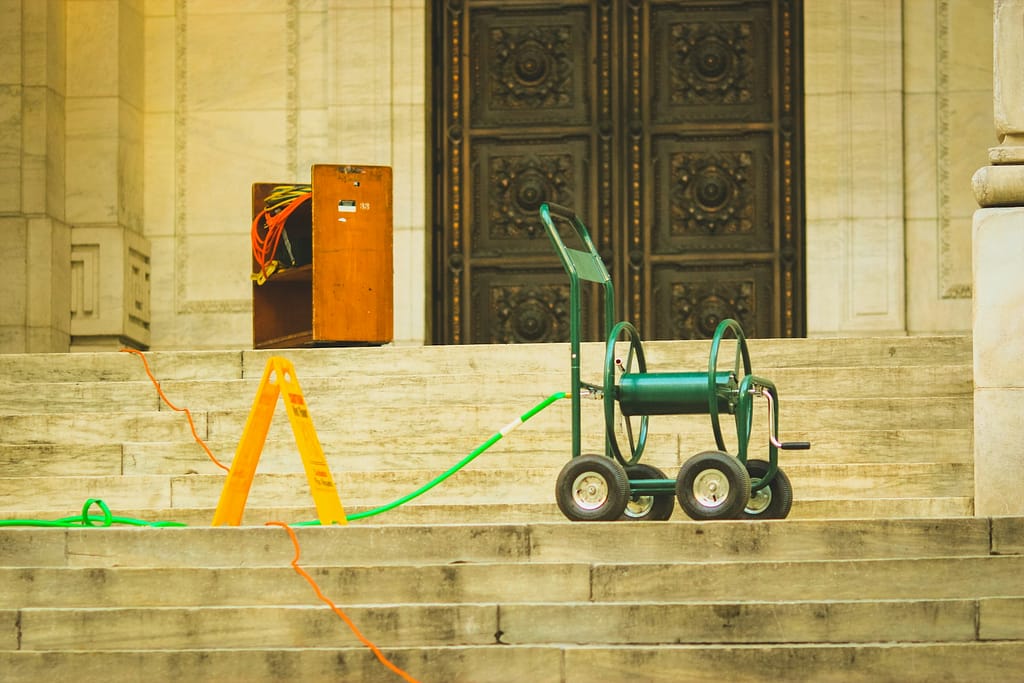Poorly placed wet floor warning sign on public steps, highlighting warning signs liability under California premises law.