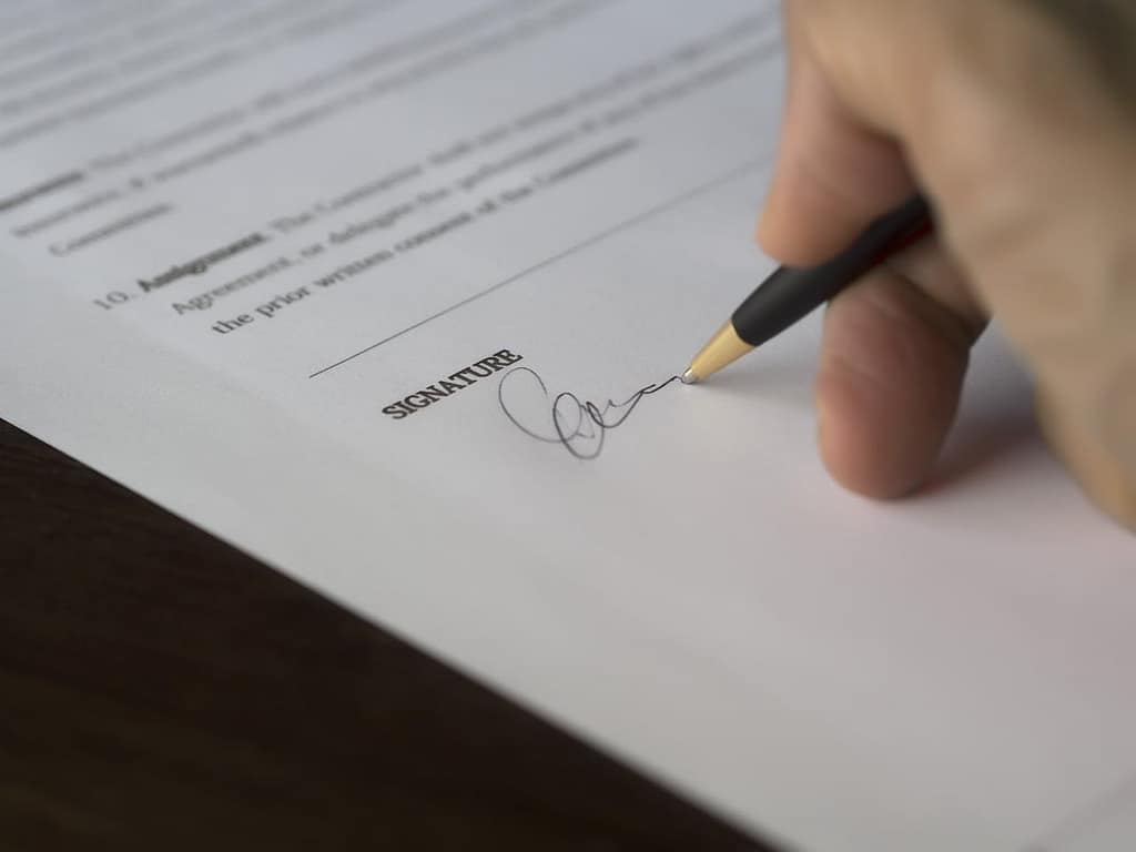 Signing a legal document related to a medical lien agreement in a personal injury claim