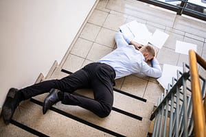 A worker falling down the stairs of a business place
