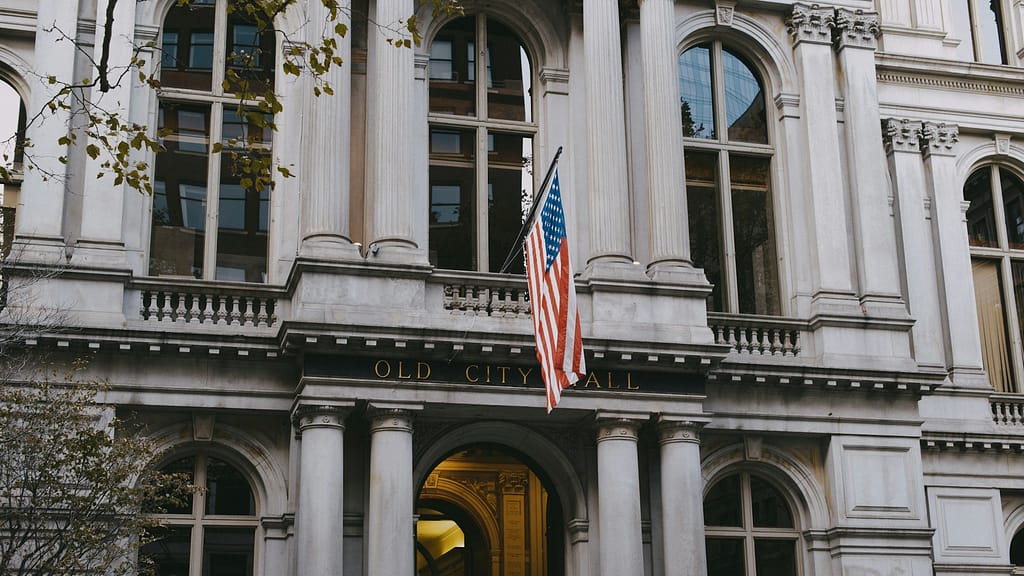 Historic government building with American flag representing public agency involvement in injury claims.

