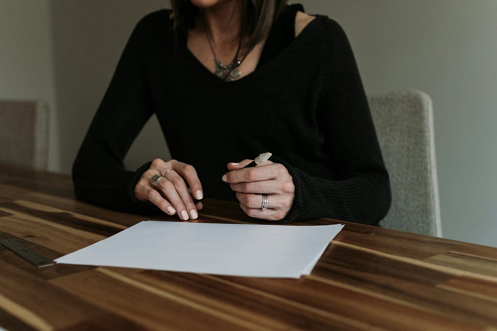 Woman reviewing vehicle documents and repair history for a potential lemon law claim in California