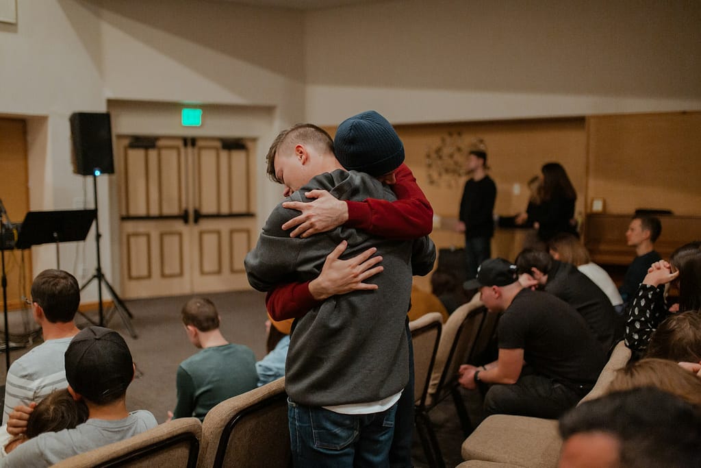 Support group members embracing during recovery after a traumatic car accident. Example of how to feel better after a car accident

