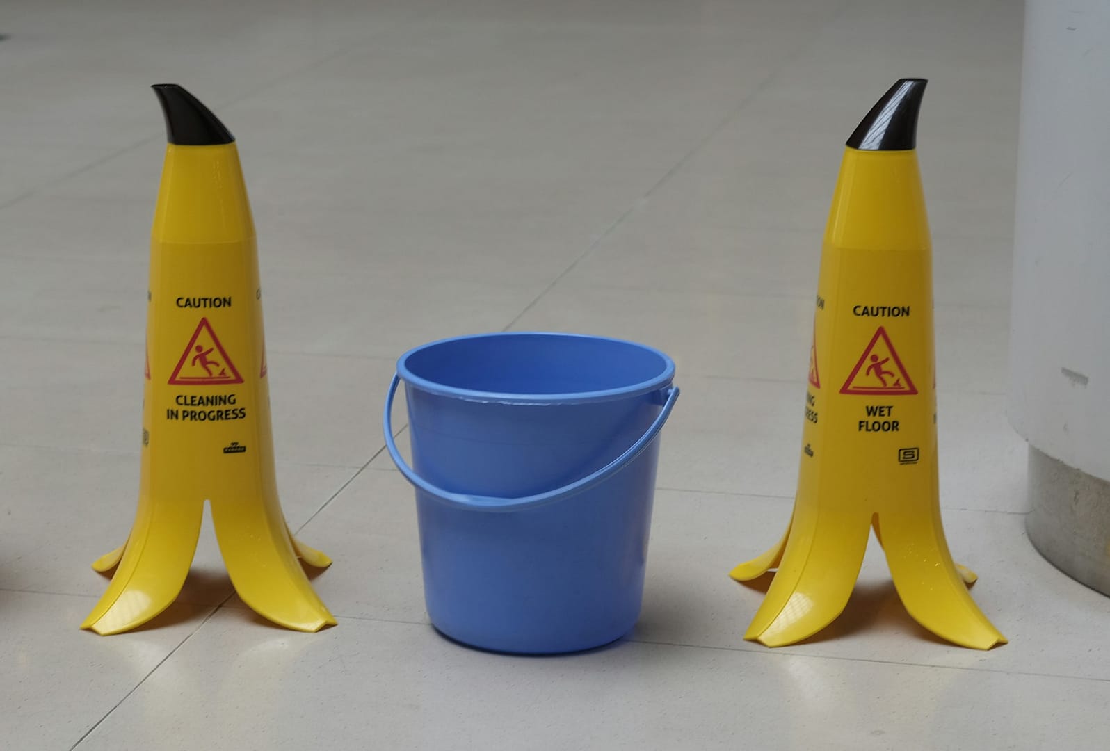 Wet floor caution signs in a public area where slip and fall injuries can occur