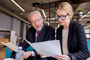 Injury lawyer reviewing evidence documents with a client in preparation for a personal injury lawsuit.