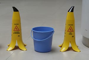 Wet floor caution signs in a public area where slip and fall injuries can occur